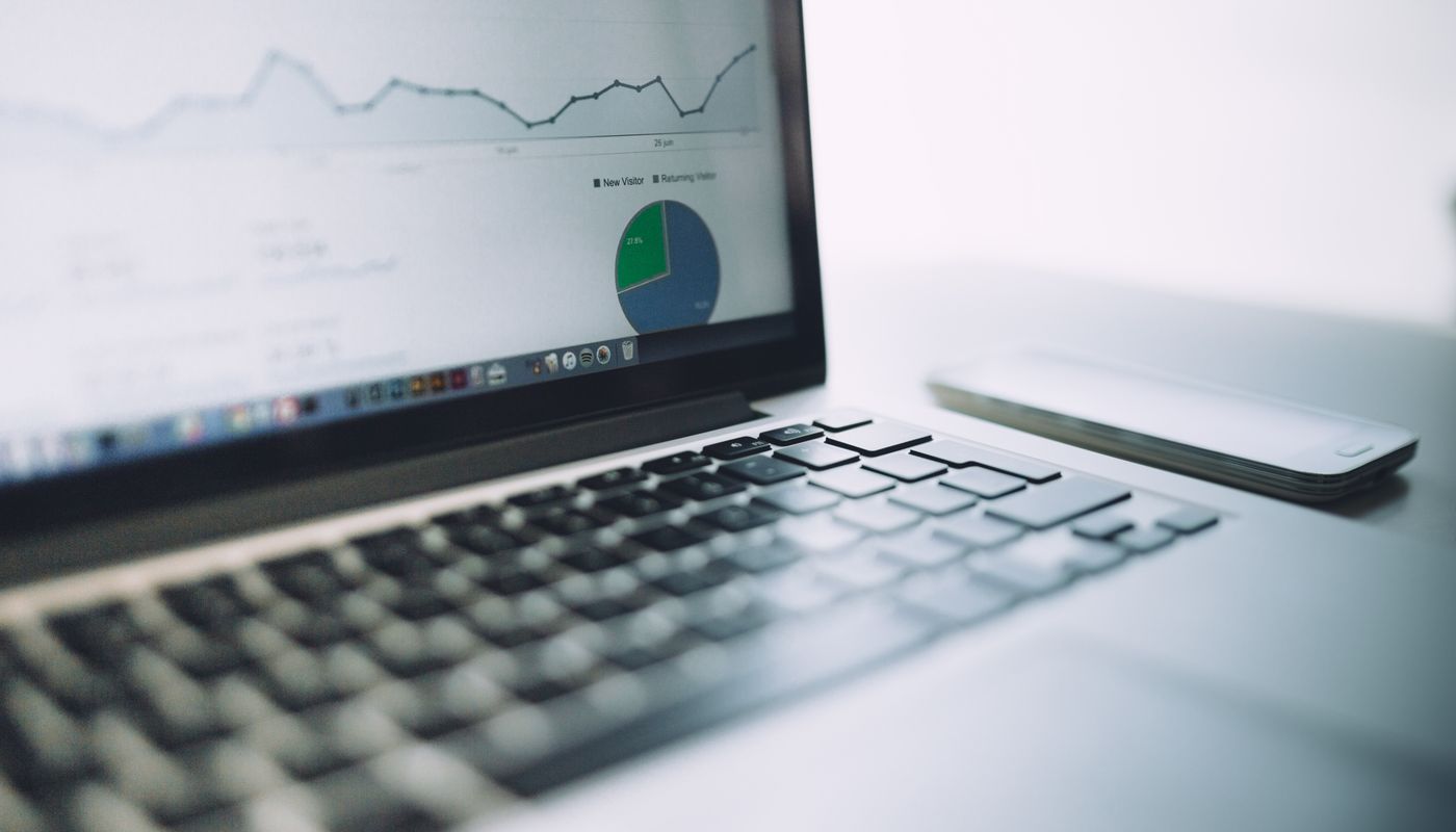 Laptop displaying an analytics dashboard beside a smartphone