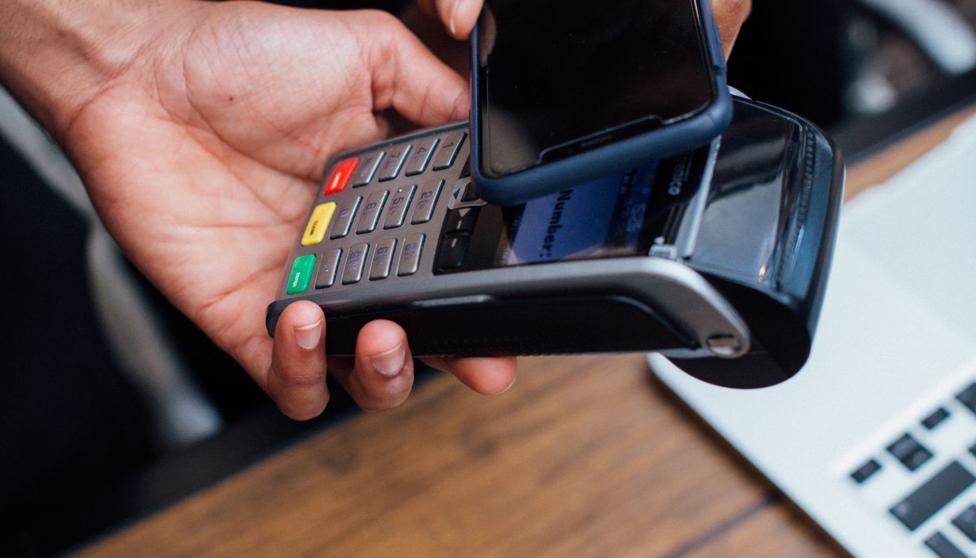 Customer making a contactless payment with a smartphone