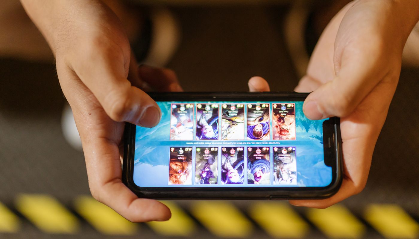Person using a mobile gaming interface on a smartphone